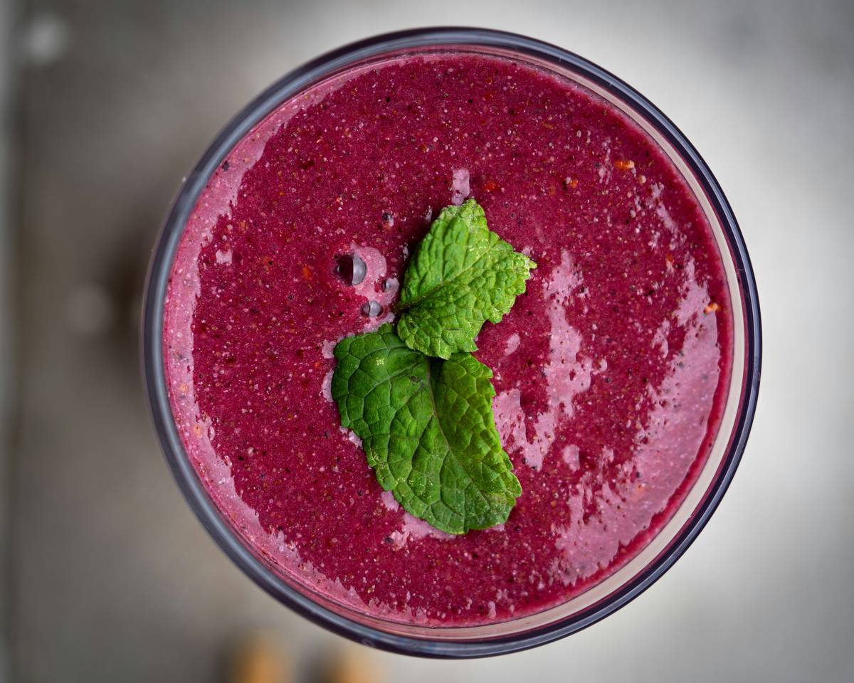 smoothies ingredients healthy and delicious: vibrant blend of spinach, banana, berries, and almond milk in a glass