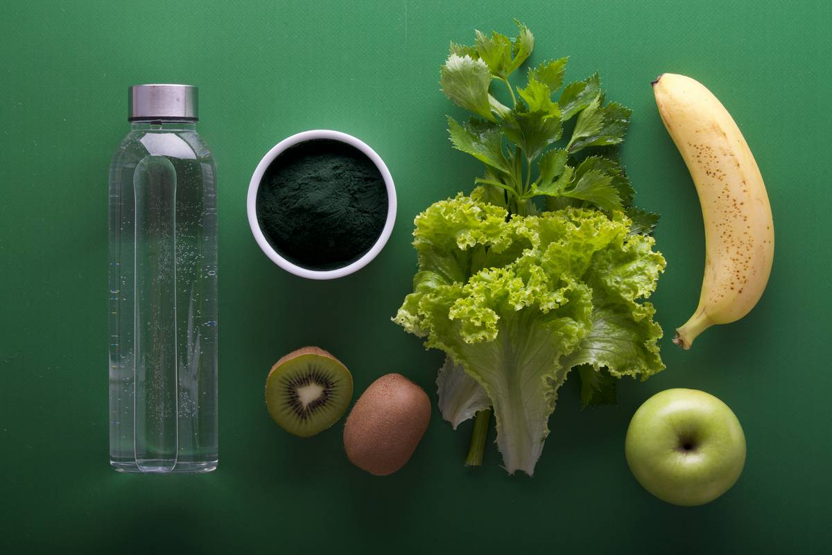 superfood smoothy organic cancer patient near being prepared in a clean kitchen with fresh kale, berries, and almond milk